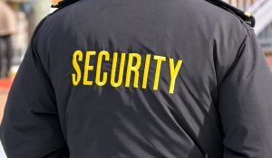 Embroidered word Security on the back of a uniform jacket