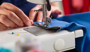 Sewing workshop. Sewing zipper on sewing machine.